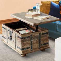 a coffee table with an open trunk on it's side and books in the middle