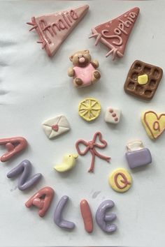 there are many different types of cookies on the table with words spelled out in front of them