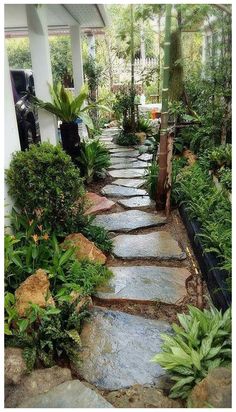 a stone path in the middle of a garden