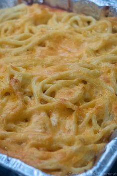 an uncooked casserole dish with noodles and cheese on it in a pan