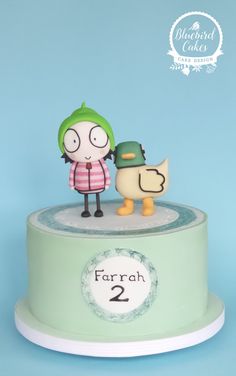 there is a cake that has two figurines on top of it, with the number 2