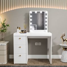 a white vanity with lighted mirror and drawers