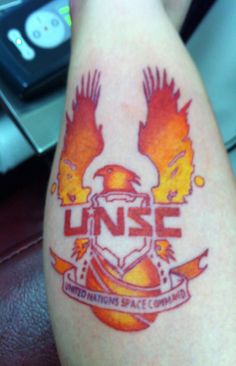 a person with a tattoo on their arm that reads unse and has two wings