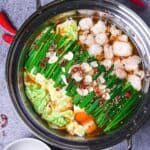 a bowl filled with food sitting on top of a table