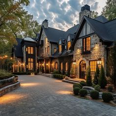 a large house with lots of windows and lights on it's front entrance area