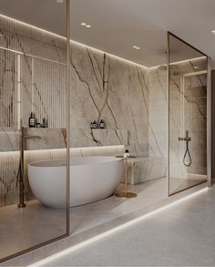 an elegant bathroom with marble walls and flooring, along with a freestanding bathtub