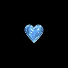 a blue heart shaped glass object on a black background with room for text or image