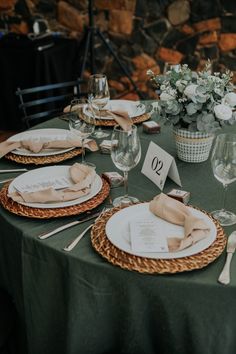 the table is set with plates and place settings