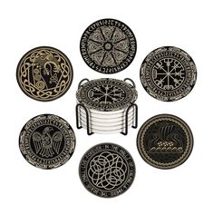 an assortment of black and gold plates with designs on them, all in the same pattern