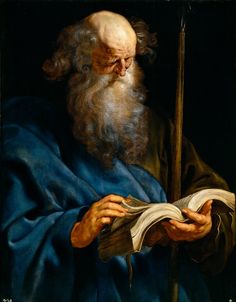 an old man with a long beard reading a book and holding a staff in his hand