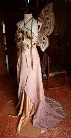 a mannequin with feathers and a butterfly on it