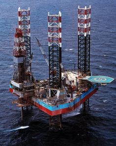 an oil rig in the middle of the ocean with lots of equipment on top of it