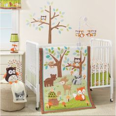 a baby crib bedding set with woodland animals and trees on it, including an owl