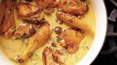 some chicken is cooking in a pot on top of the stove and it's ready to be eaten