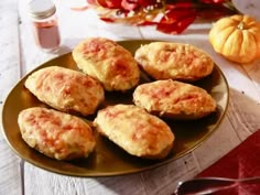 some biscuits are sitting on a plate next to pumpkins