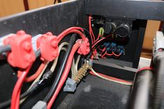 the inside of an electrical box with wires and plugs