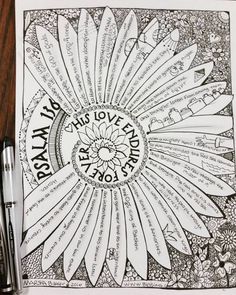 an adult coloring book with flowers and words on the pages, surrounded by pens and markers