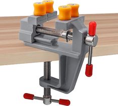 a bench vise with two vices on the top and three screws on the bottom