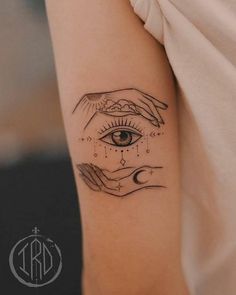 a woman's arm with an all seeing tattoo on it