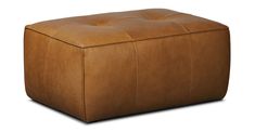 a large brown leather ottoman sitting on top of a white floor