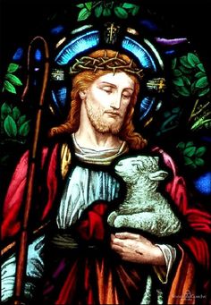 jesus holding a lamb in front of a stained glass window