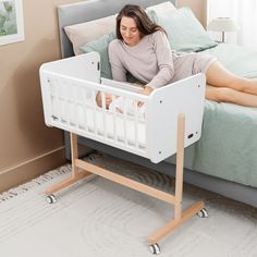 a woman laying in her crib on the floor