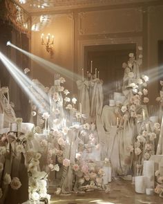 a room filled with lots of white and pink flowers