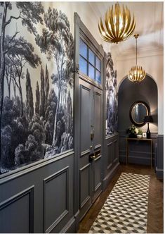 the hallway is decorated with wallpaper and an elegant chandelier hanging from the ceiling