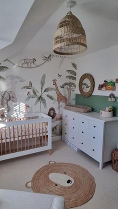 a baby's room decorated in white and green