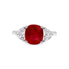 This beautiful ring centers a captivating 3.25ct ruby unearthed from a newly discovered mine in Greenland, where the gems are said to be the oldest on Earth. These gems have been buried under the Polar Ice Cap, which is now slowly melting to reveal these unique, billion-year-old treasures. This ruby is flanked by two epaulette diamonds mounted in platinum. Handcrafted and one-of-a-kind. 3.25ct vivid red cushion ruby; Greenland government certificate 2 epaulette diamonds totaling 0.84ct E color V Brilliant Cut Ruby Gemstones Fine Jewelry, Brilliant Cut Ruby Gemstones For Fine Jewelry, Red Diamond With Prong Setting, Formal Ruby Three-stone Rings, Gia Certified Ruby Ring, Red Diamond Gemstones With Prong Setting, Formal Red Three Stone Ruby Ring, Formal Red Ruby Ring With Three Stones, Formal Ruby Three Stone Ring