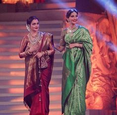 two women standing next to each other in sari dresses on stage with lights behind them