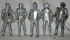 five silver robot toys are lined up in a row