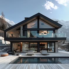 a house with a pool in front of it and snow covered mountains behind the house