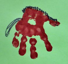 a child's handprint with a red horse on it