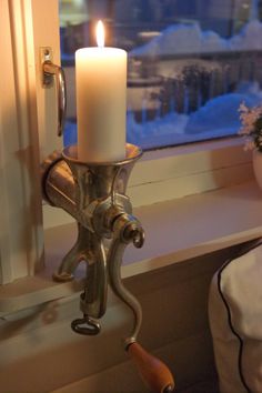 a candle is lit in front of a window