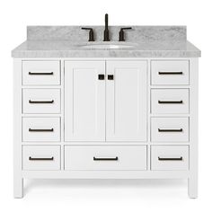 a white bathroom vanity with marble top and drawers