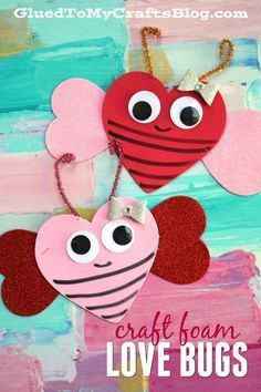 two paper hearts with googly eyes on them and the words craft foam love bugs