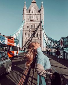 a woman standing in front of the tower bridge