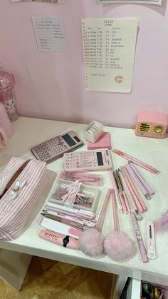 the desk is covered with pink items and accessories