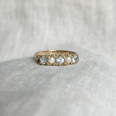 A demure vintage 9 carat gold topaz and pearl ring. All vintage rings are one-off, high-quality pieces that have been pre-loved. A sustainable choice, they are designed to last a lifetime. BAND: 9k gold. STONE: topaz and pearl. SIZE: UK Q, USA 8 (we do not re-size, please contact a reputable local jeweller). HALLMARKS: hallmarked 9 carat, Birmingham, 1986. SHIPPING: all vintage rings come with complimentary shipping. GIFTING: all rings come packaged in our signature gift box. RETURNS: 16 days re Pearl Ring Vintage, Vintage Pearl Ring, Pearl Rings Vintage, Gold Vintage Ring, Topas Ring, Gold Topaz, Vintage Pearl, November Birthstone, Gold Stone