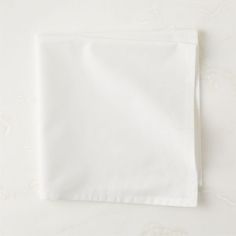 a plain white napkin folded on top of a table