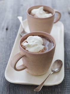 two cups of hot chocolate with whipped cream