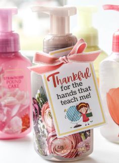 three bottles with hand soaps in them and a sign that says, thank for the hands that teach me