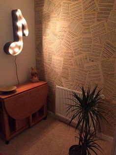 a room with a musical note on the wall and a potted plant next to it