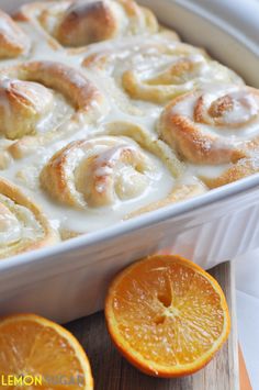 an image of orange rolls with icing in the pan