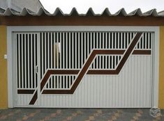 a white garage door with brown lines painted on it