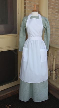 Pioneer & LDS Trek Clothes | Pinafore apron has a solid neck strap w/ability to be folded down at waist & ties in the back.Slimming&protective. Get one today!White Elegance Pioneer Woman Dress, Trek Clothing, Pioneer Costume, 1800s Clothing, Pioneer Clothing, Pioneer Dress, Farm Fashion, Simple Dress Pattern, White Elegance