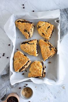 several scones on a tray with chocolate chips