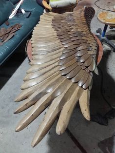 a large wooden bird sculpture sitting on top of a table