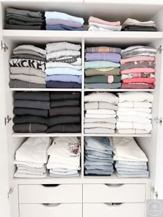 a white closet filled with lots of folded shirts and pants on top of it's drawers